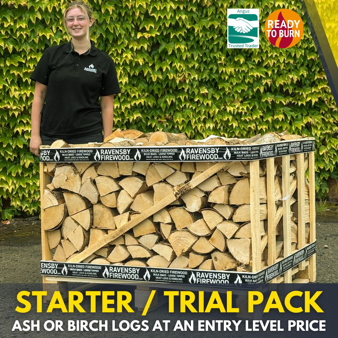 Ravensby Firewood staff standing next to a 1.3m3 stack of Kiln-Dried Ash firewood 