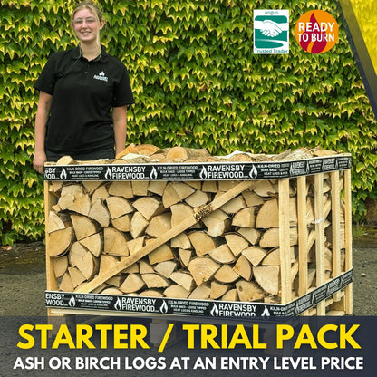 Ravensby Firewood staff standing next to a 1.3m3 stack of Kiln-Dried Ash firewood 