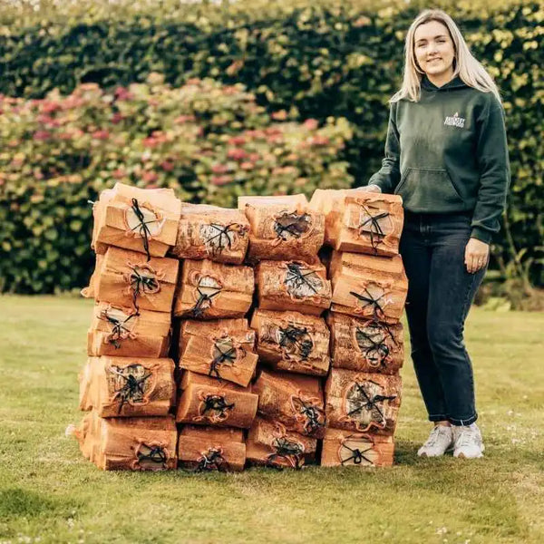 Emma Ravensby Firewood standing next to stacks of grab nets ready for delivery to Brechin