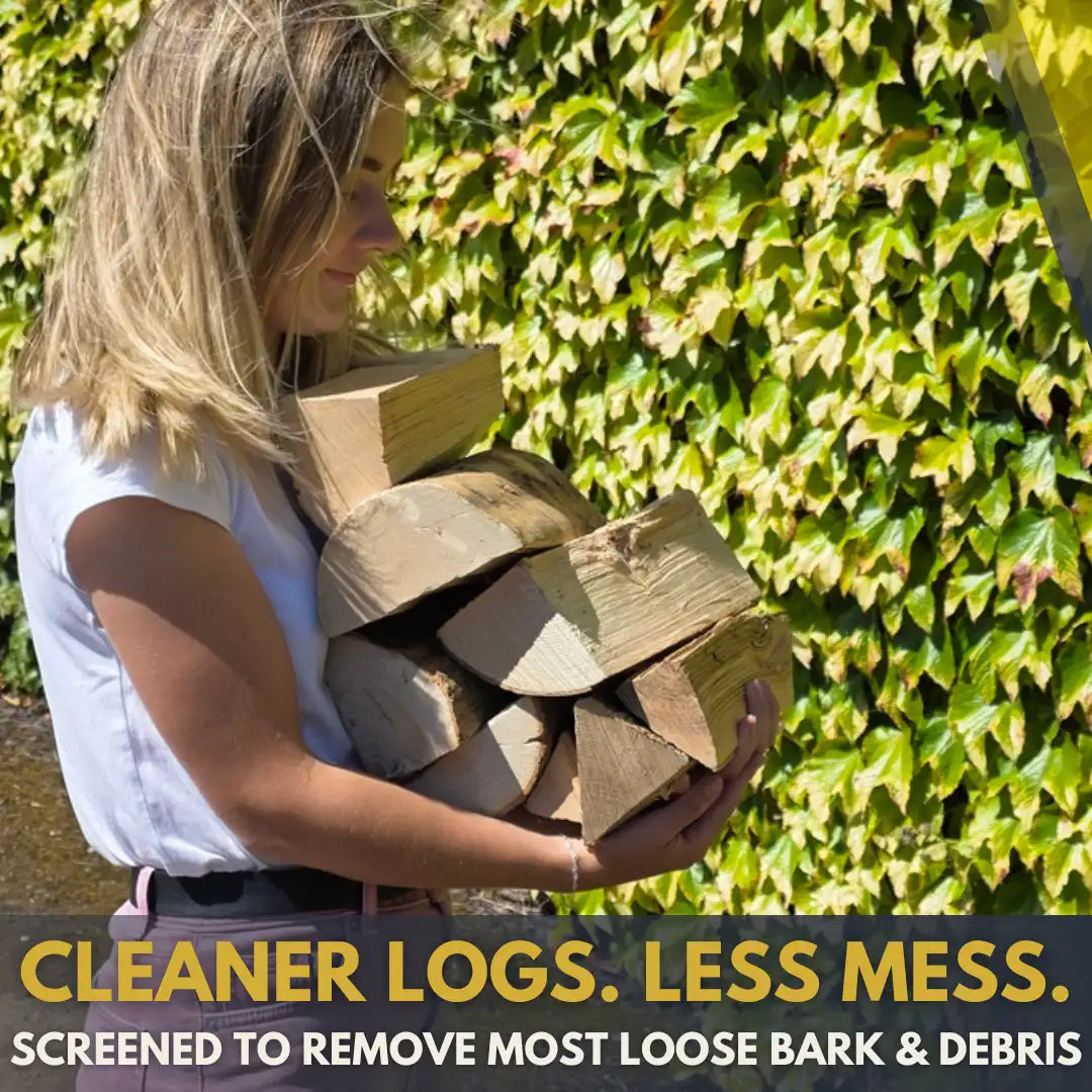A woman outdoors holding a pile of cut kiln-dried firewood logs, with a background of green ivy. Text at the bottom reads 'CLEANER LOGS. LESS MESS'