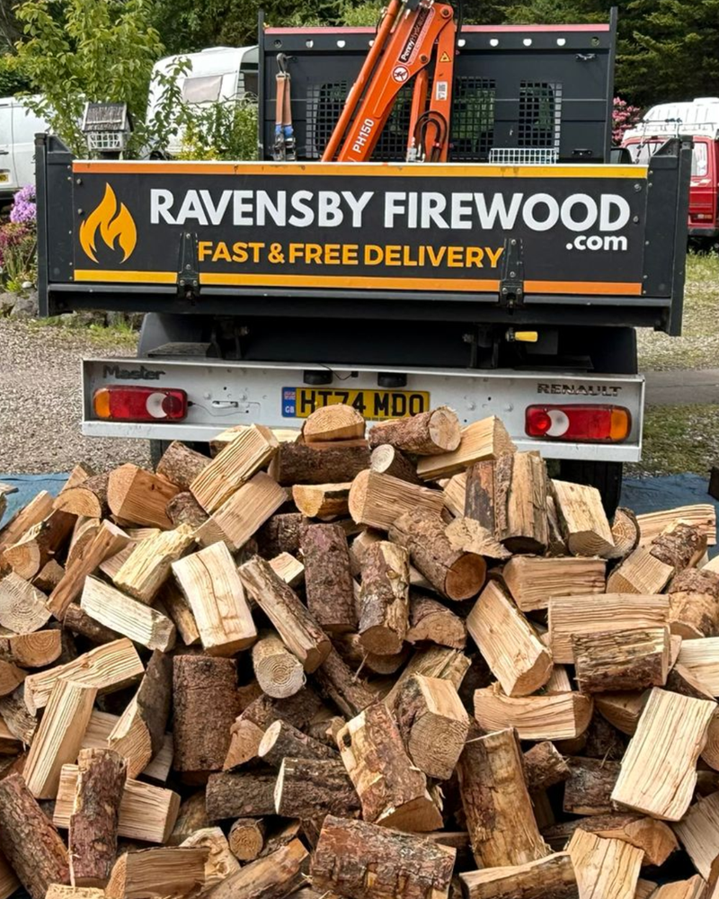 Truck with 'Ravensby Firewood' branding and a pile of kioln-dried hardwood logs in Blairgowrie