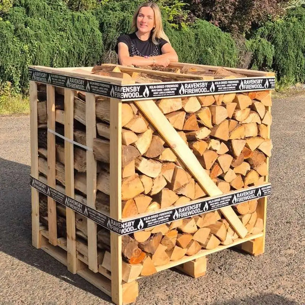 Woman standing next to Ash firewood with 'Ravensby Firewood' branding ready for delivery to the Scottish Islands.