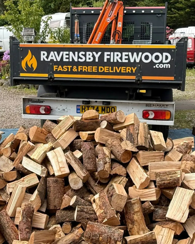 Truck tipping loose tipped firewood logs at a delivery in Stonehaven